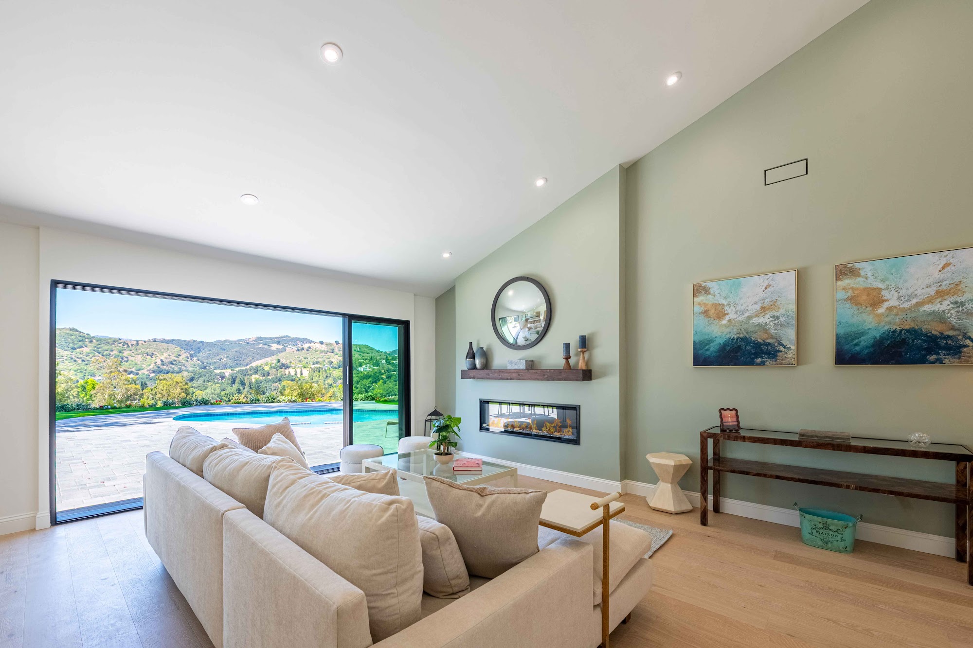 Living room with fireplace and hillside view