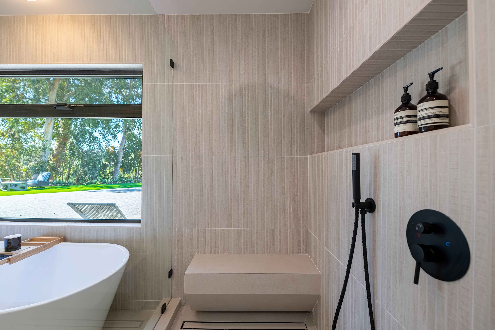 Primary bath with soaking tub and rift-oak tile